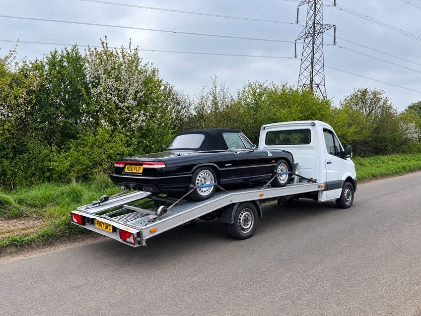 Black classic convertible secured on the back of the AL Services car transporter